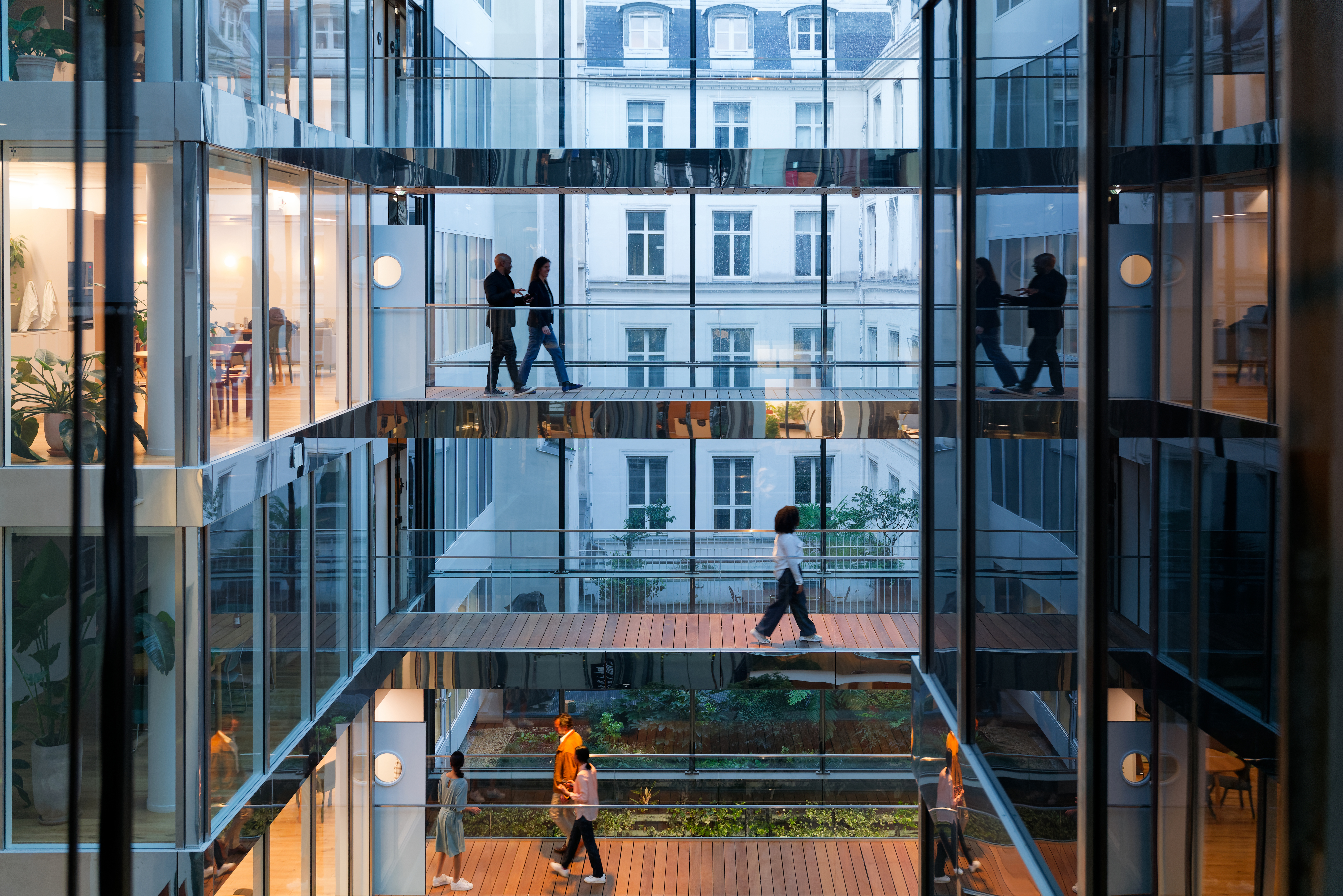 modern building in Paris, the walls are made of glass, at the end of the day, taken slightly against the light, wide view