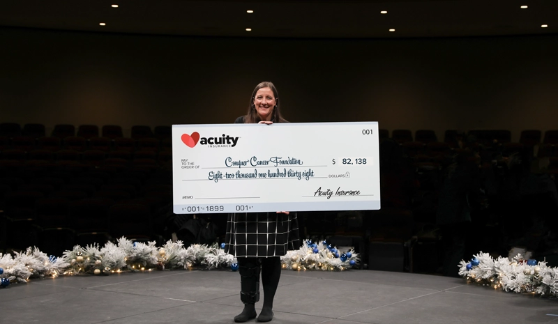 Conquer Cancer: Kate Brunner Quinn from Conquer Cancer, the ASCO Foundation, accepts a check for more than $82,000 from Acuity.