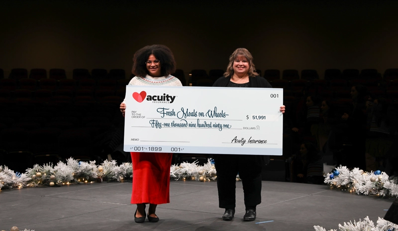 Fresh Meals on Wheels: Lindsey Thomson and Allison Thompson from Fresh Meals on Wheels accept a check for nearly $52,000 from Acuity.