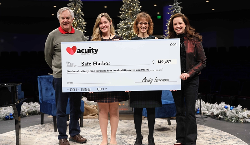 Safe Harbor: Safe Harbor’s Kelsi Engelhardt accepts a check for nearly $150,000 from Acuity CEO Ben Salzmann, Vice President - Services and Administration Sheri Murphy, and President Melissa Winter. 