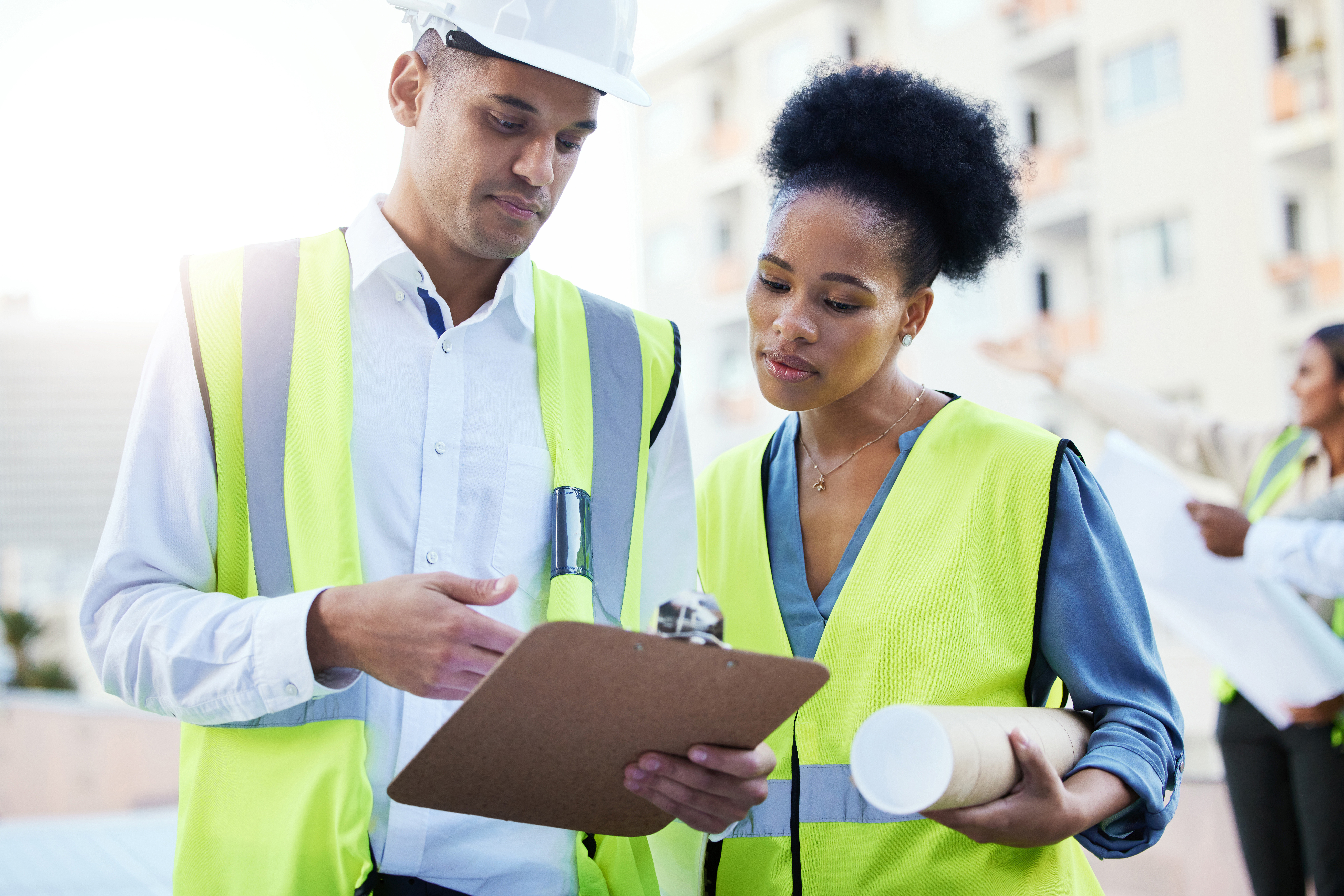 Clipboard, construction and team of people planning paperwork of property, engineering and architecture. Black woman, man and project management for industrial buildings, collaboration and logistics.