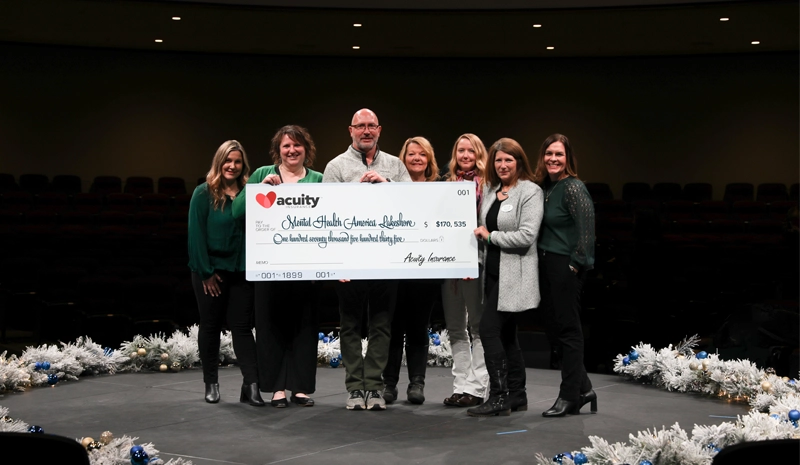 Mental Health America Lakeshore: Andrea Fischer, Dawn Rousse, Mark Kesler, Liz Kesler, Julie Preder, Sandy Leske, and Anna Grunwald from Mental Health America Lakeshore accept a check for more than $170,000 from Acuity.