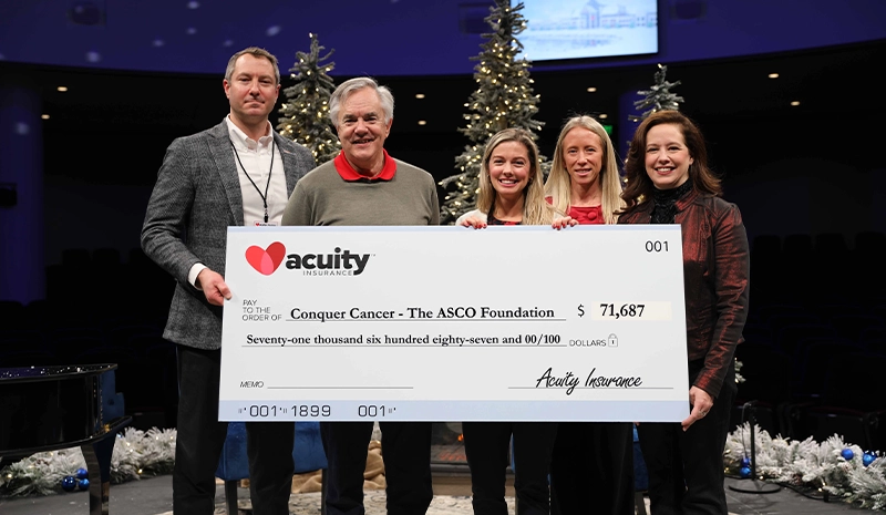 •\t4 Conquer Cancer: David Lowing and Cooper Pate from Conquer Cancer, the ASCO Foundation, accept a check for more than $71,000 from Acuity CEO Ben Salzmann, General Manager - Commercial Underwriting Alissa Burgos, and President Melissa Winter. 